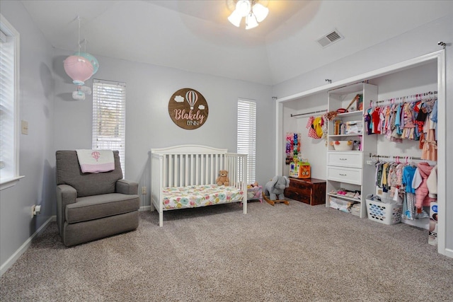 bedroom featuring ceiling fan, a closet, vaulted ceiling, and carpet