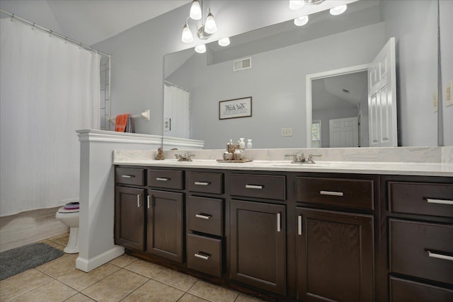 bathroom with vanity, toilet, and tile patterned flooring