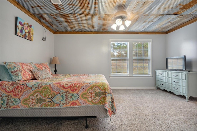 carpeted bedroom featuring wood ceiling, ornamental molding, and ceiling fan