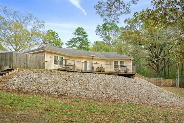 back of property featuring a wooden deck