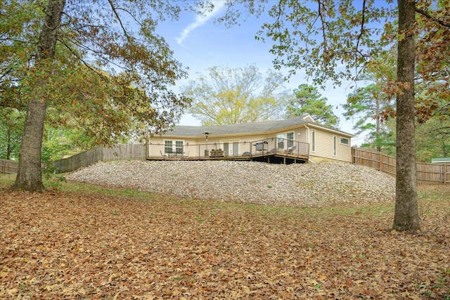 back of house featuring a deck