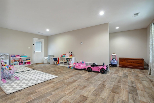 recreation room with light hardwood / wood-style flooring