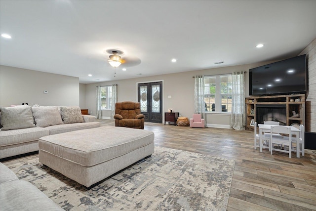 living room with plenty of natural light and light hardwood / wood-style flooring