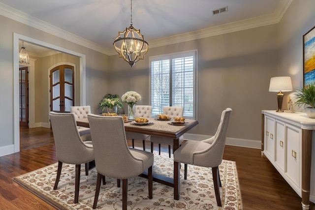 dining space with ornamental molding, dark hardwood / wood-style flooring, and a notable chandelier