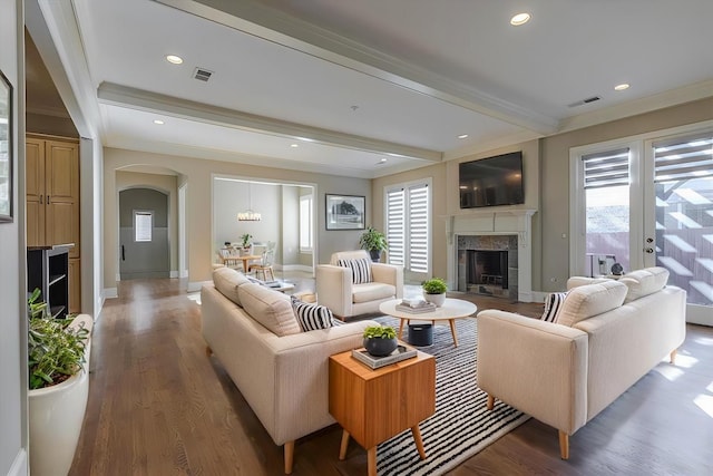 living room with plenty of natural light, beam ceiling, and hardwood / wood-style floors