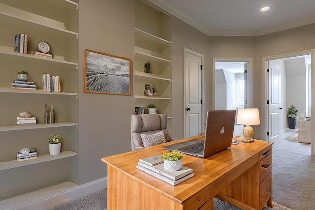 office featuring ornamental molding, light colored carpet, and built in features