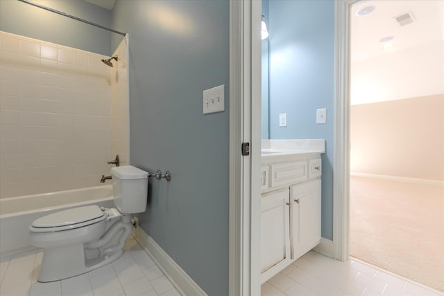 full bathroom with tiled shower / bath, vanity, toilet, and tile patterned floors