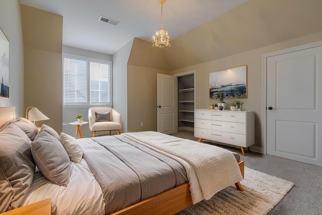 bedroom with an inviting chandelier, carpet flooring, and vaulted ceiling