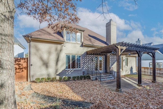 back of house featuring a pergola