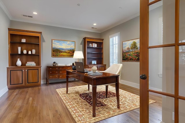 office space featuring ornamental molding and light hardwood / wood-style floors