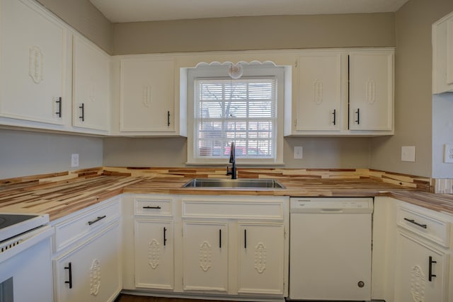 kitchen with sink, white appliances, and white cabinets