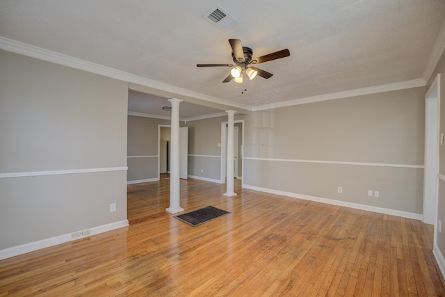 unfurnished room featuring ornate columns, ornamental molding, ceiling fan, and light hardwood / wood-style floors