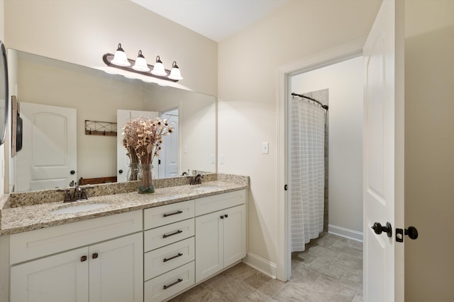 bathroom featuring vanity and curtained shower