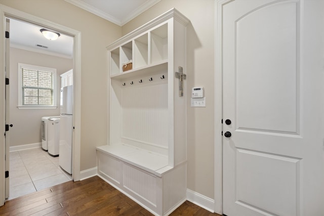 mudroom featuring crown molding, wood-type flooring, and washing machine and clothes dryer