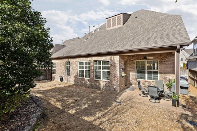 rear view of property with ceiling fan and a patio area