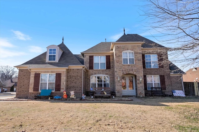 view of front of property with french doors and a front yard