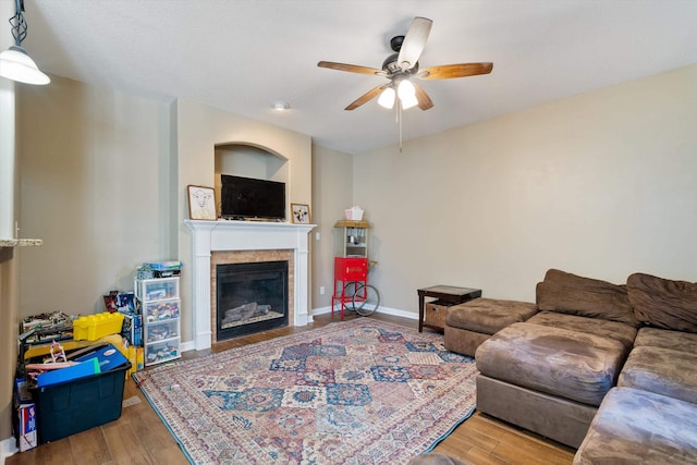 living room featuring wood-type flooring and ceiling fan