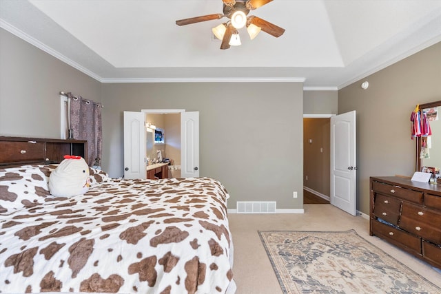 bedroom featuring ceiling fan, ornamental molding, a tray ceiling, and light carpet