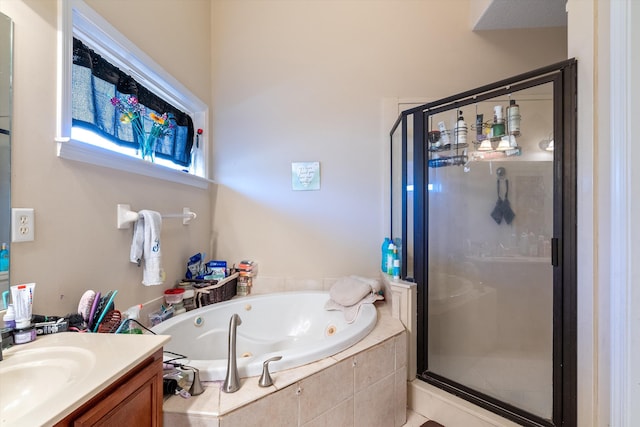 bathroom with vanity and shower with separate bathtub