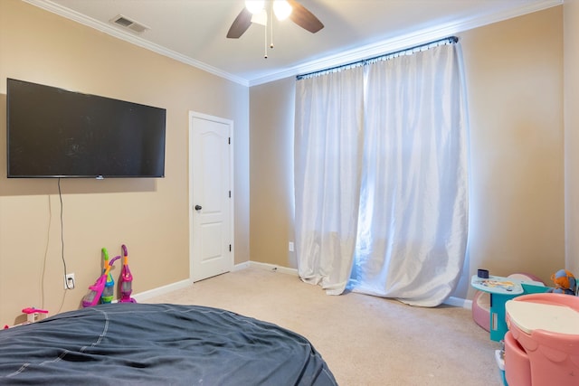 carpeted bedroom with ornamental molding and ceiling fan