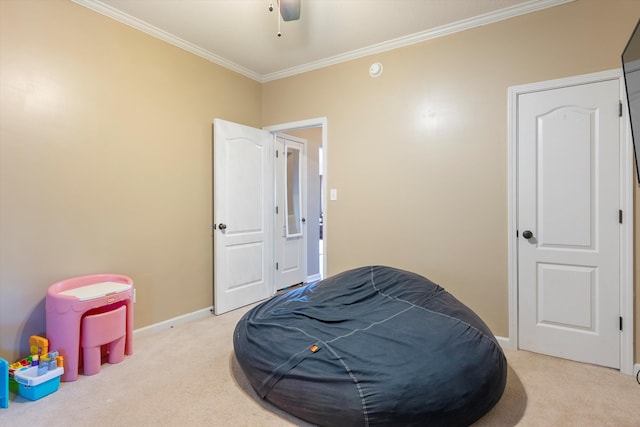 bedroom featuring ornamental molding, light colored carpet, and ceiling fan