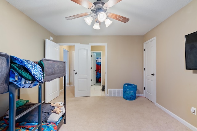 bedroom featuring light colored carpet and ceiling fan