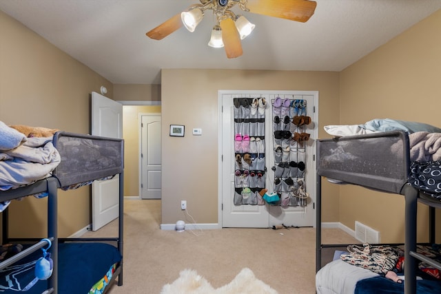 bedroom with ceiling fan and light colored carpet