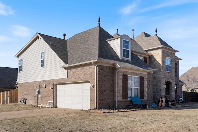 view of side of property featuring a yard and a garage