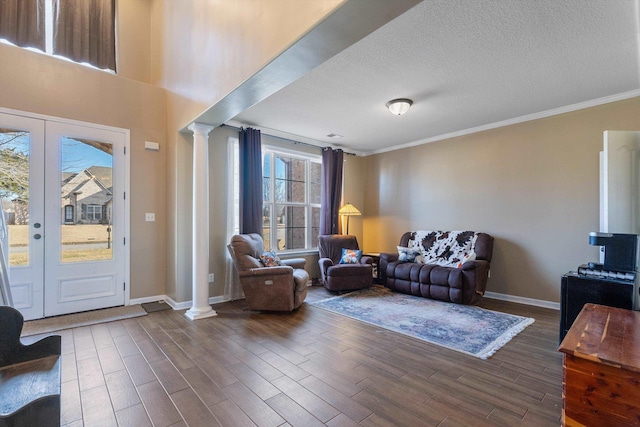 living room with french doors, ornamental molding, dark hardwood / wood-style floors, and ornate columns