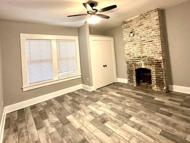 unfurnished living room featuring ceiling fan, a fireplace, and hardwood / wood-style floors