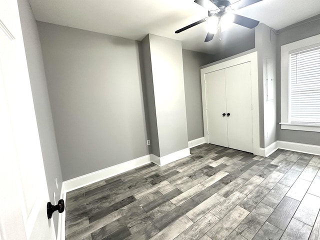 unfurnished bedroom featuring hardwood / wood-style floors, a closet, and ceiling fan