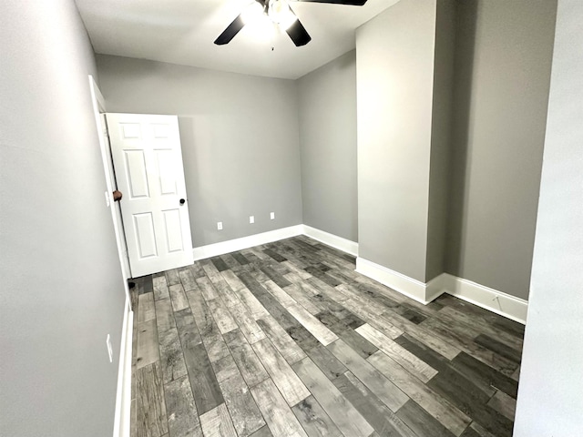 spare room featuring dark hardwood / wood-style floors and ceiling fan