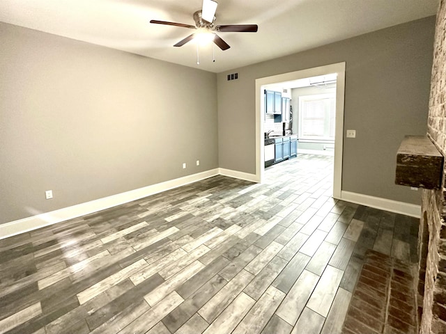 empty room with hardwood / wood-style floors and ceiling fan