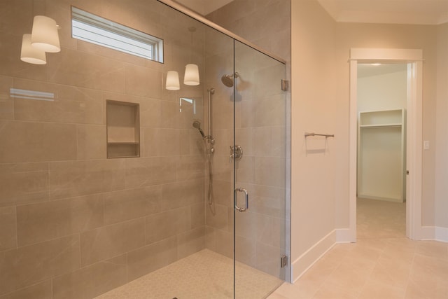 bathroom with tile patterned flooring and an enclosed shower