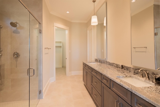 bathroom with ornamental molding, vanity, a shower with door, and tile patterned floors