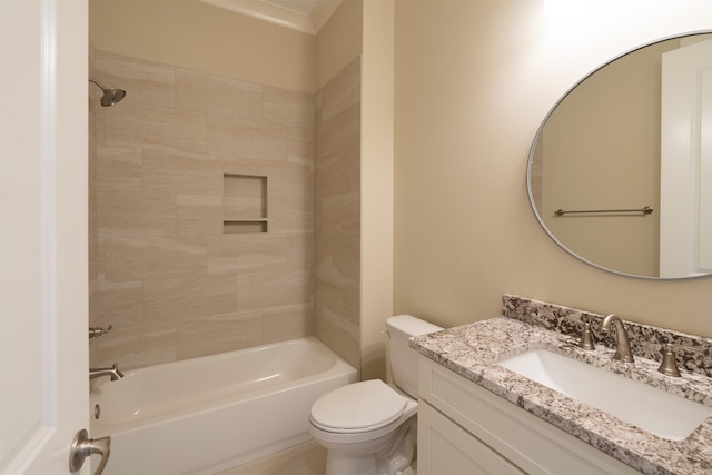 full bathroom featuring tiled shower / bath, vanity, and toilet