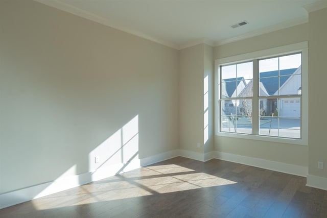 empty room with ornamental molding and light hardwood / wood-style floors