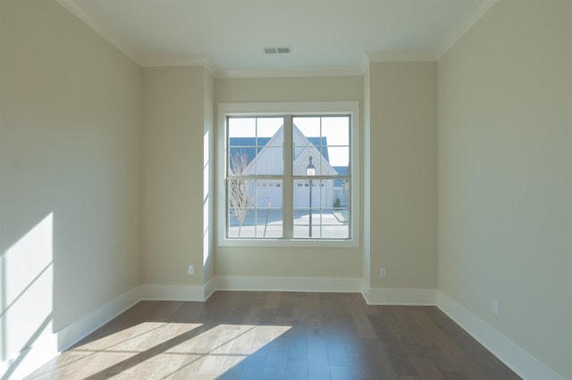 empty room featuring hardwood / wood-style flooring and crown molding