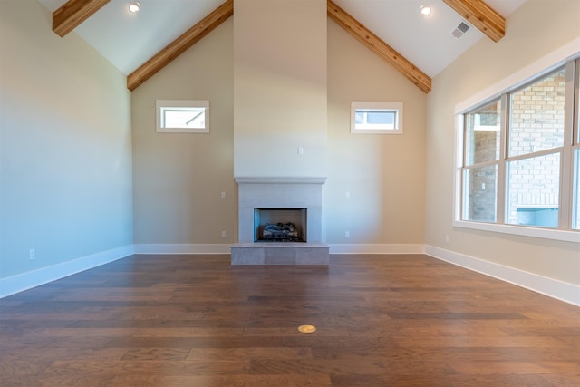 unfurnished living room featuring dark wood-type flooring, a fireplace, high vaulted ceiling, and beamed ceiling