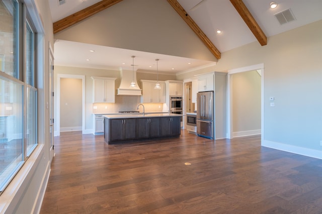 kitchen featuring premium range hood, appliances with stainless steel finishes, a kitchen island with sink, and white cabinets