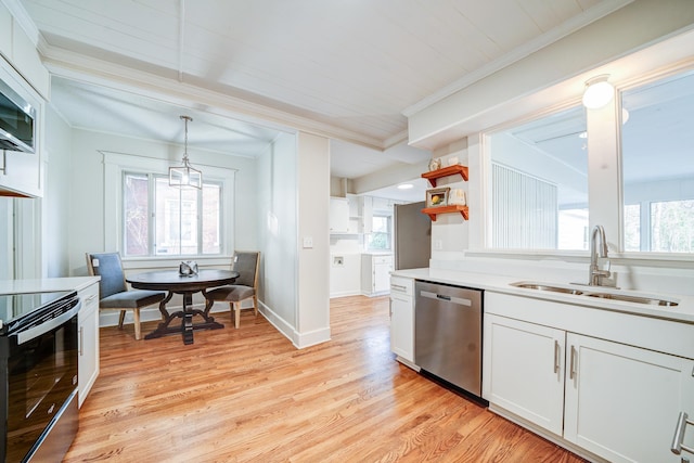 kitchen with pendant lighting, black electric range oven, sink, white cabinets, and stainless steel dishwasher