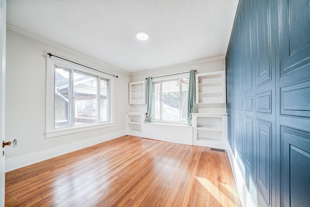 interior space featuring crown molding and light hardwood / wood-style floors