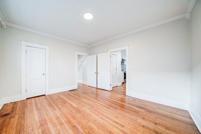 spare room with crown molding and light hardwood / wood-style flooring