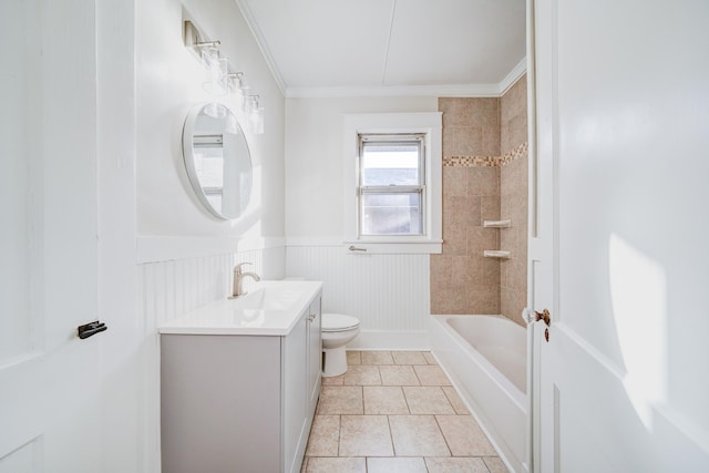 full bathroom featuring crown molding, vanity, tile patterned floors, toilet, and tiled shower / bath