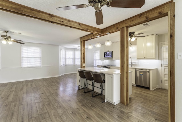 kitchen with a kitchen island, beamed ceiling, white cabinets, dark hardwood / wood-style flooring, and stainless steel appliances