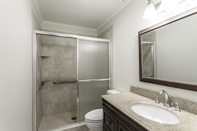 bathroom featuring ornamental molding, toilet, a shower with door, and vanity