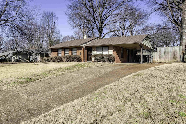 ranch-style house with a carport and a front lawn