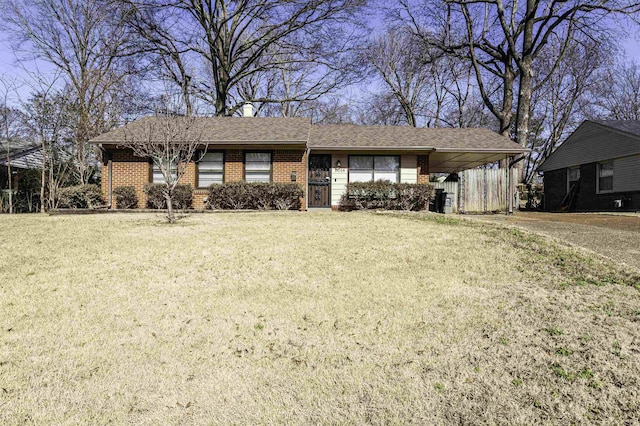 ranch-style home featuring a carport and a front lawn