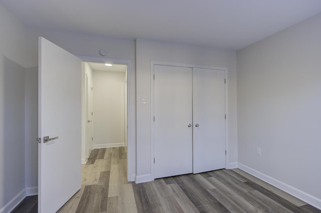 unfurnished bedroom featuring a closet and light wood-type flooring