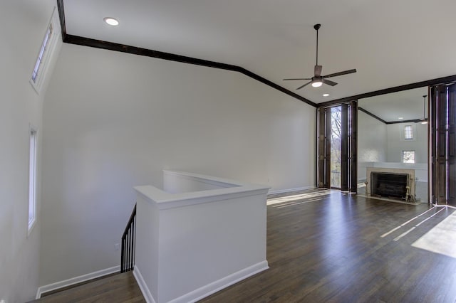 interior space featuring crown molding, vaulted ceiling, ceiling fan, and dark hardwood / wood-style flooring